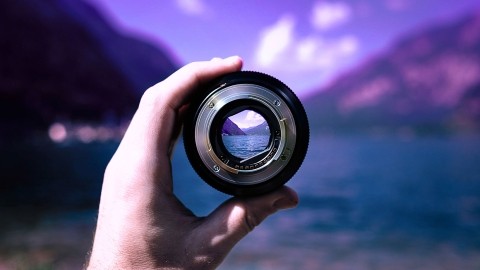 Image of a mountain and sea horizon seen through a lens